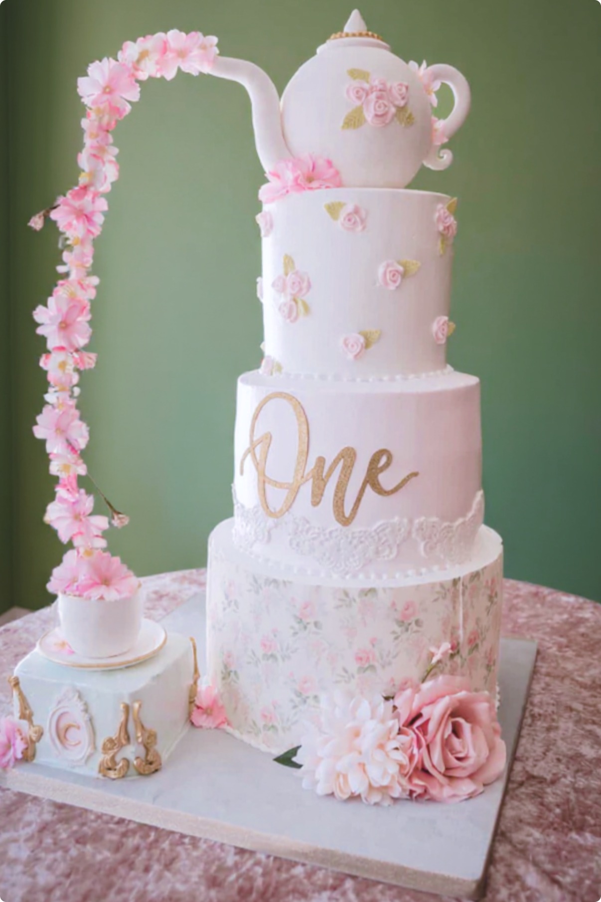 Sage and ivory two-tier custom cake with fresh florals